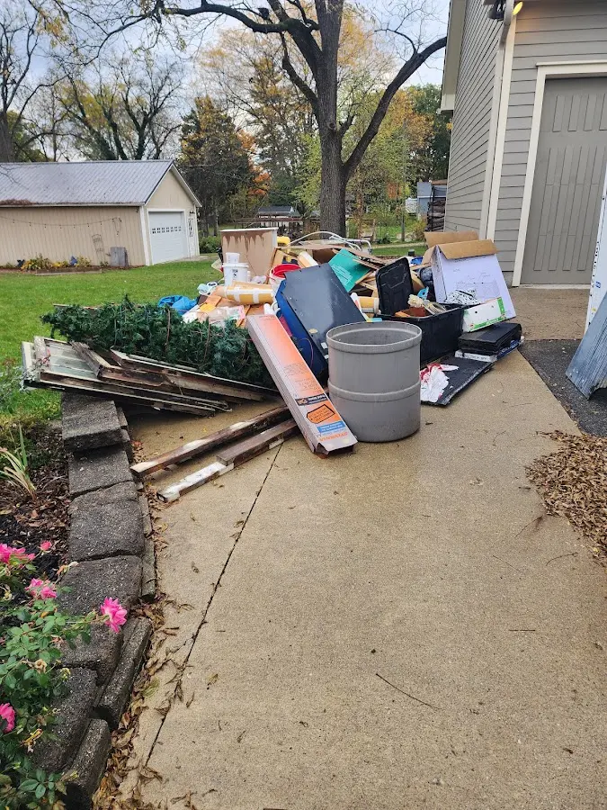 Dumpster being loaded with debris for 12 Yard Dumpster Rental in Blackstone